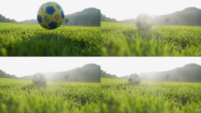 足球草地滚动足球落地瞬间小孩踢足球玩耍