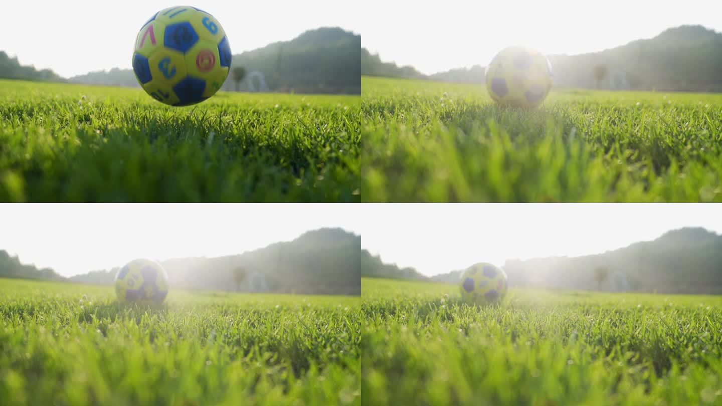 足球草地滚动足球落地瞬间小孩踢足球玩耍