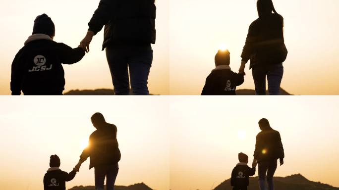 温馨母子妈妈牵着小男孩一起看日落夕阳散步