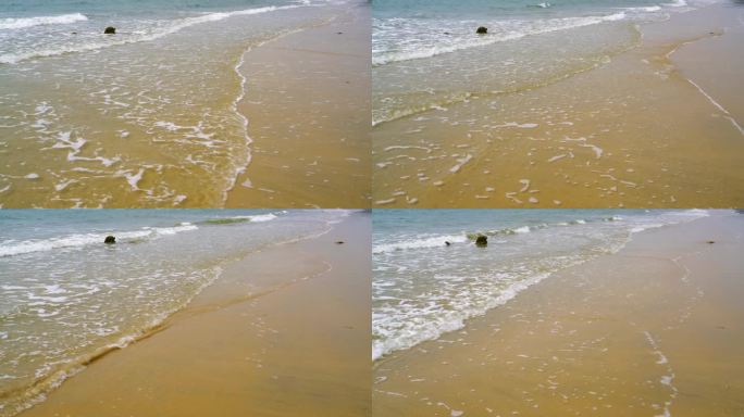 海滩海浪拍在沙滩上