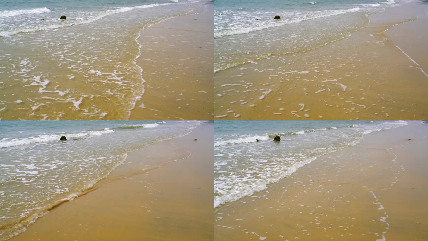 海滩海浪拍在沙滩上
