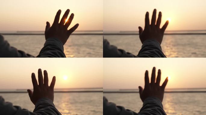 手指抚摸夕阳阳光