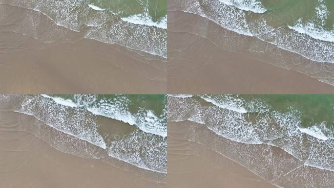 海浪后浪拍前浪消失在沙滩上