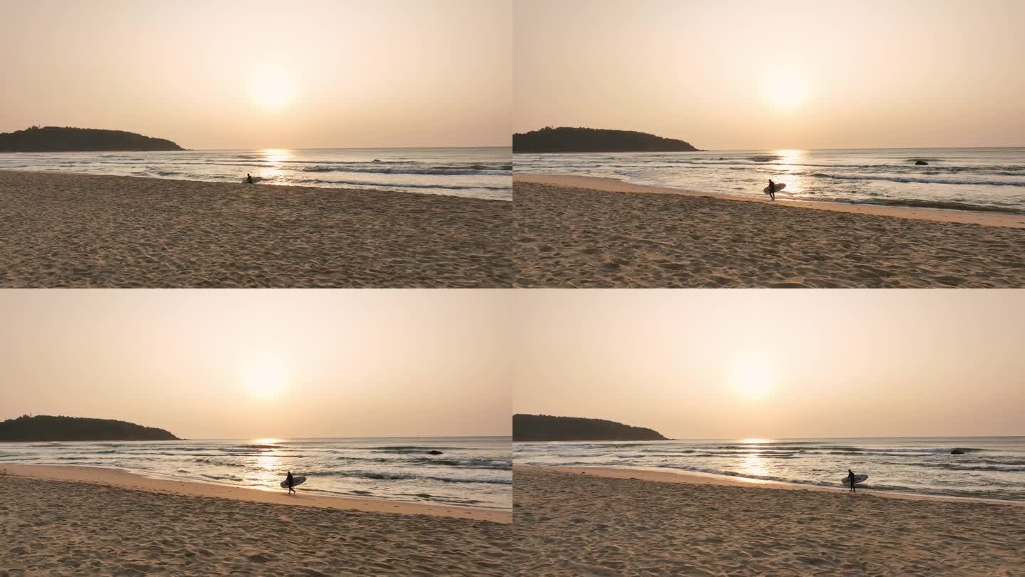 日出分冲浪者拿着冲浪板走在海边沙滩滩