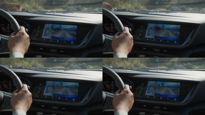 驾驶汽车行驶在农村道路上 大屏幕显示路况