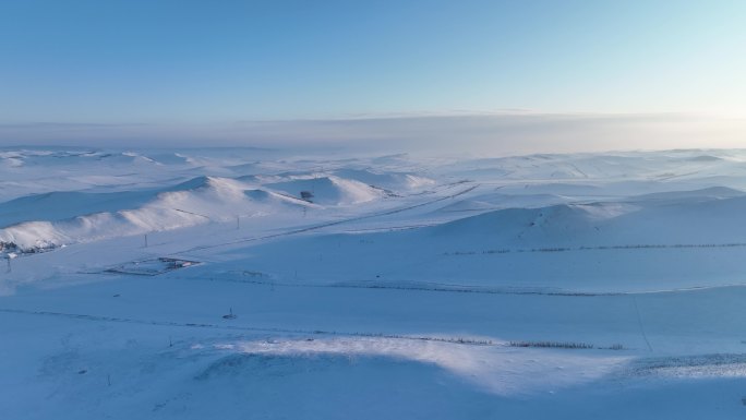 航拍建有风力发电风机的雪域雪原