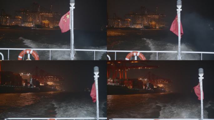 夜晚从船上看灯火通明的码头带五星红旗