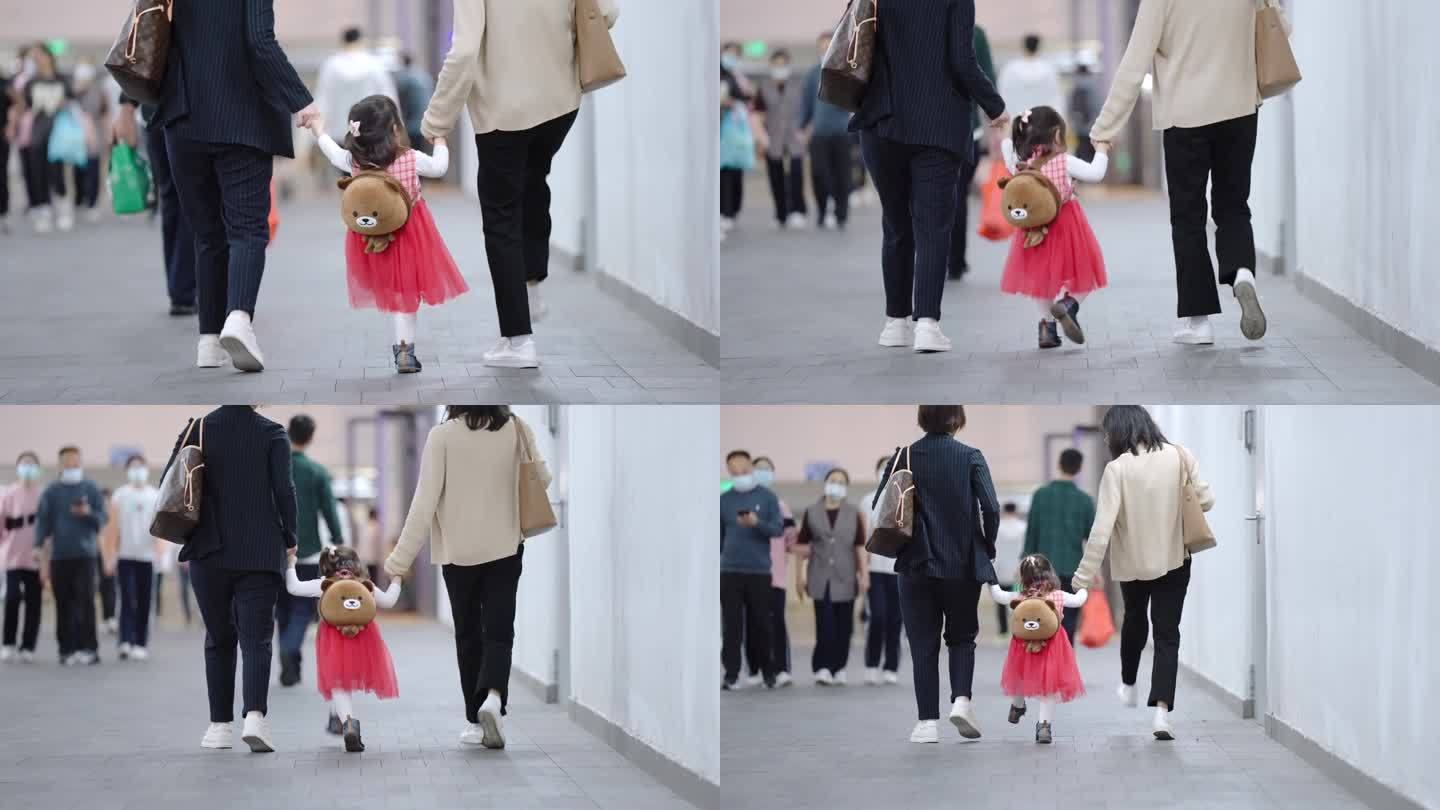 母亲手牵手带小孩走路