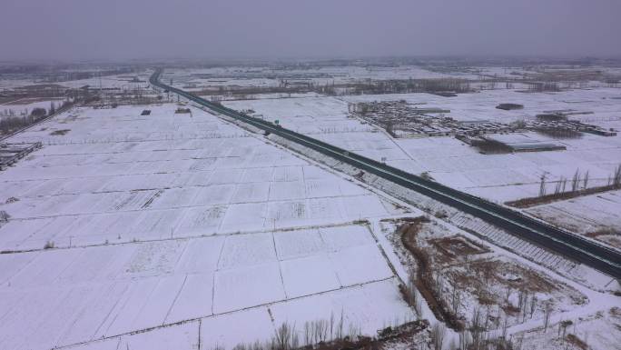 阴雪天航拍农村田野高速公路