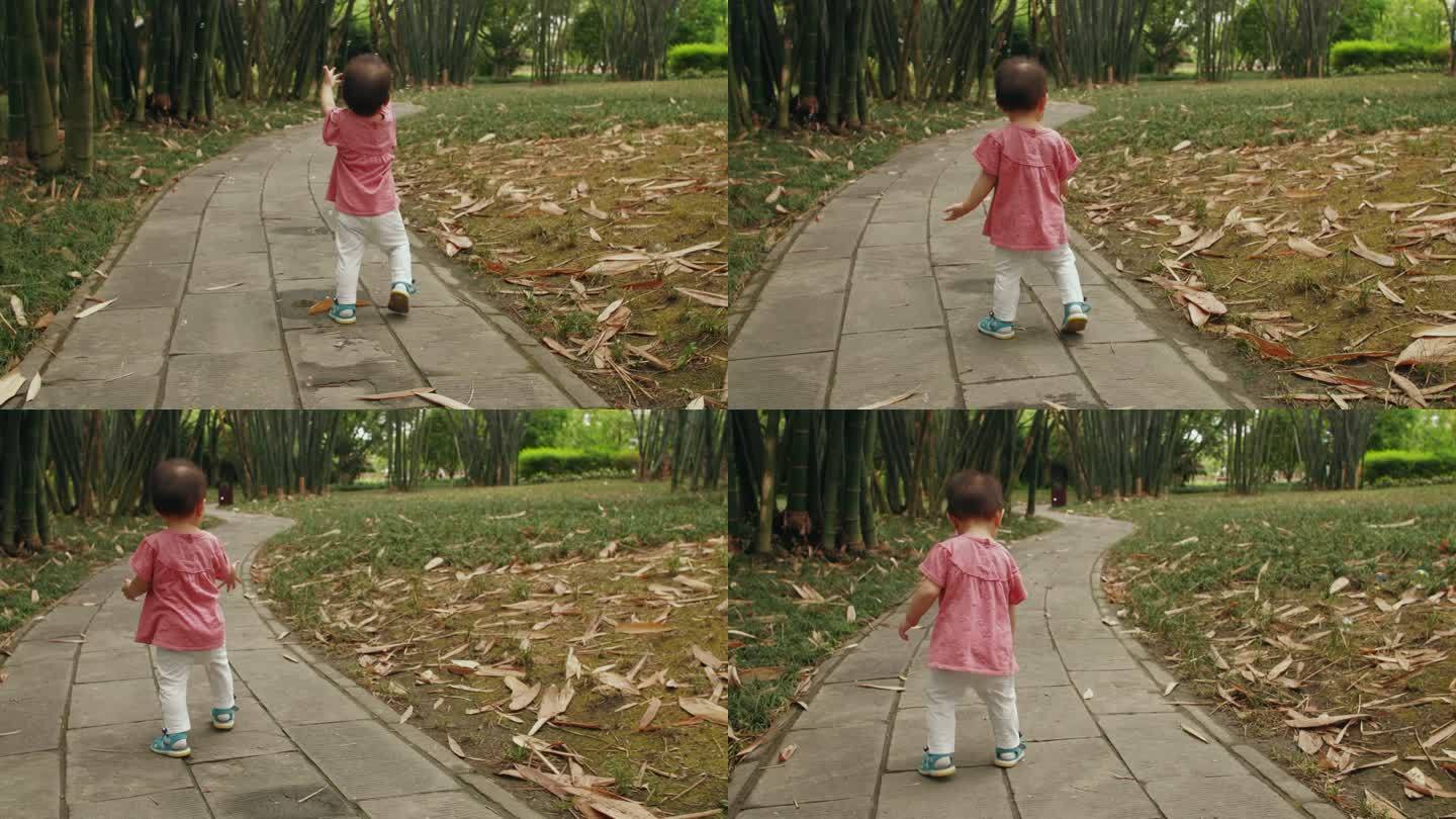 蹒跚学步的可爱小婴儿在公园里玩耍抓泡泡