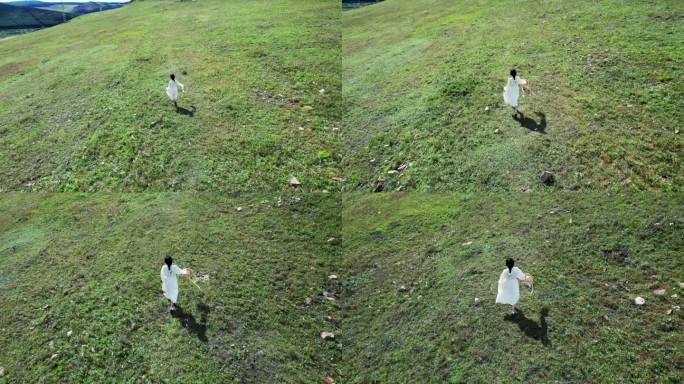 穿着白裙子的女孩在草地上奔跑