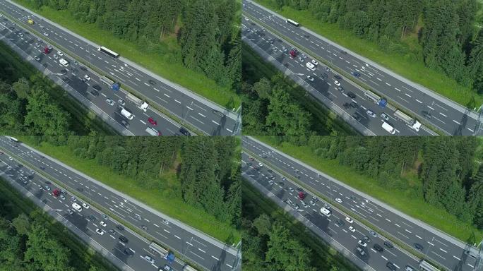 空中: 无数的汽车和卡车驶过高速公路上的瓶颈。