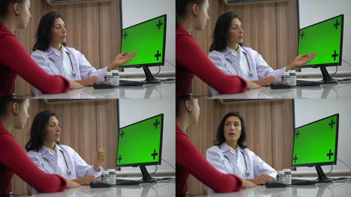 医生在绿屏计算机上与患者讨论结果