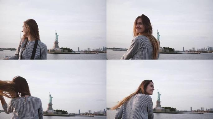 快乐的旅游女人的肖像，头发飞舞，从船上慢动作在自由女神像上享受纽约天际线