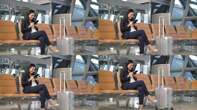 在机场使用手机的女商人