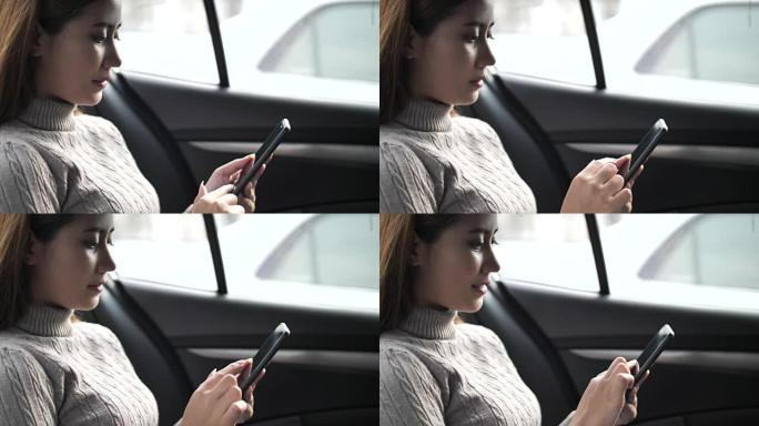 在汽车上使用智能手机的女人