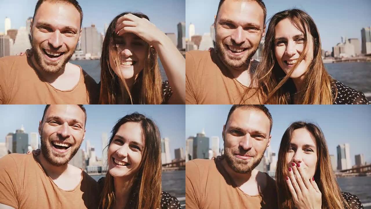 快乐微笑的年轻新婚夫妇在纽约曼哈顿天际线景观与朋友在线视频聊天时向相机挥手致意
