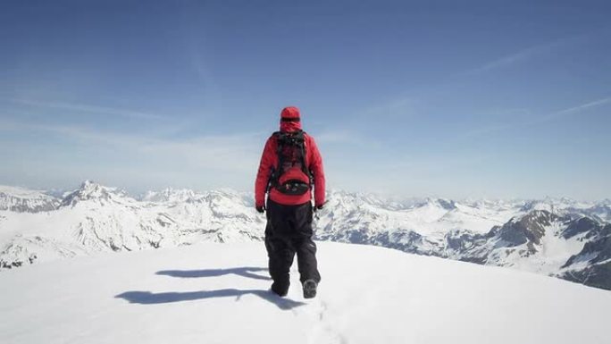 登山者在白雪覆盖的山峰上行走