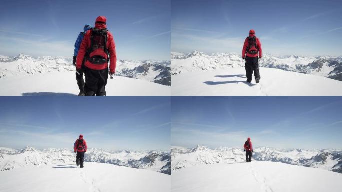 登山者在白雪覆盖的山峰上行走