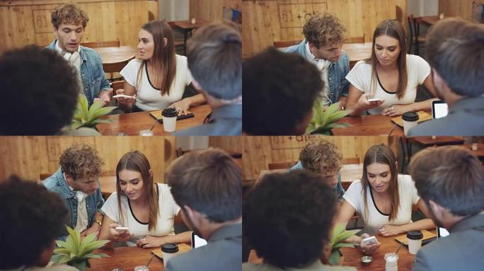 咖啡馆里的一群人看着智能手机