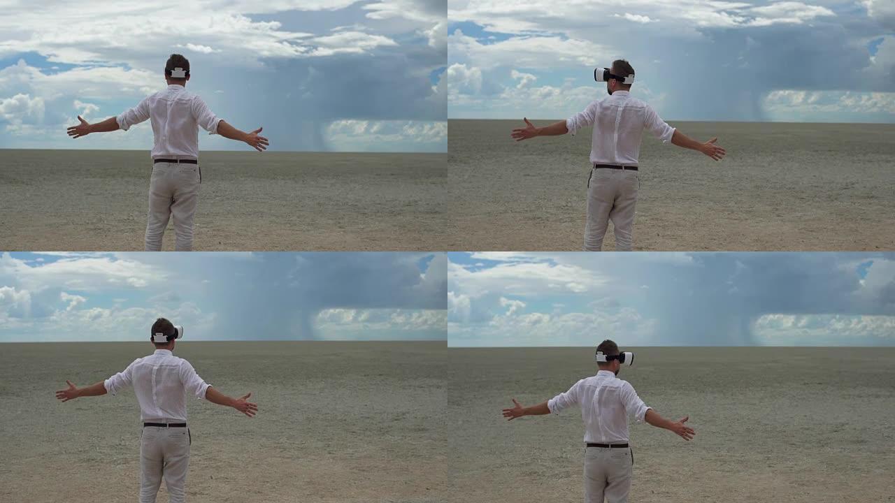在沙漠上戴着虚拟google的男人