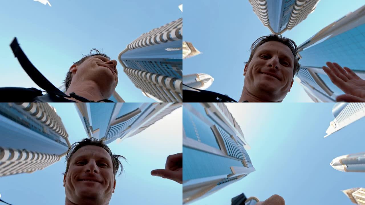 一名男子在迪拜摩天大楼下自拍