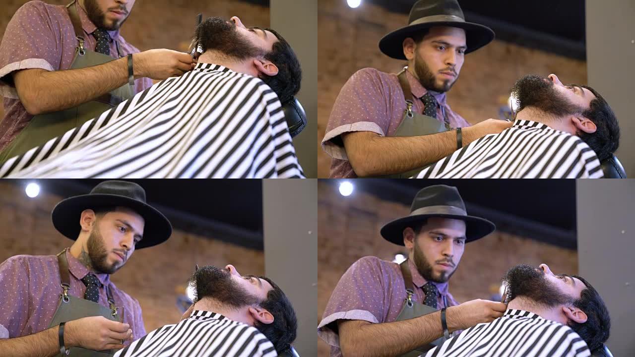 沙龙中年轻的理发师修剪客户的胡须