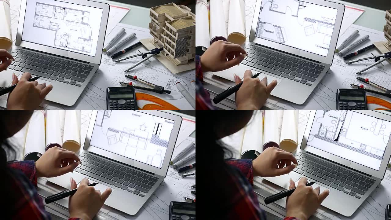 建筑师使用笔记本电脑通过房屋模型和绘图工具检查蓝图
