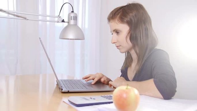 年轻女子在笔记本电脑上学习和研究