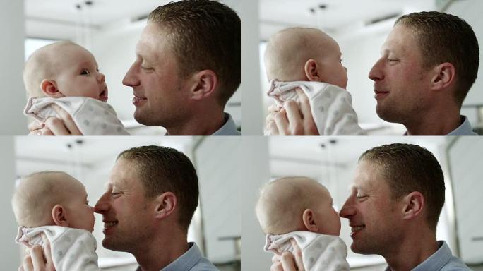 父亲和婴儿用鼻子像爱斯基摩人一样接吻
