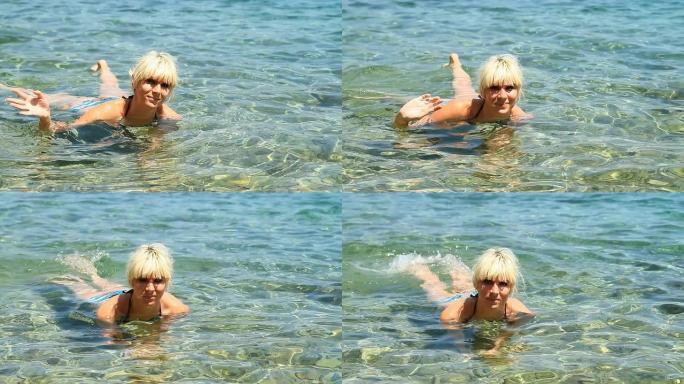 高清：女子在海里游泳时挥手