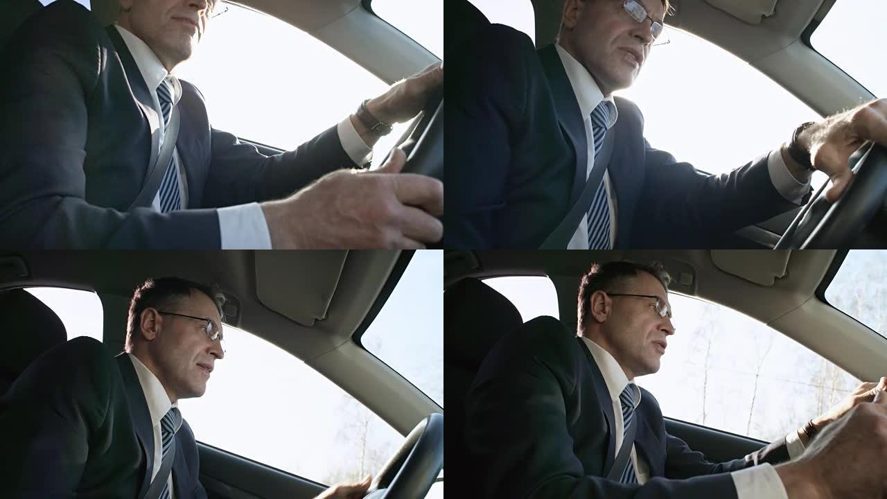 戴眼镜的忙碌男子开车