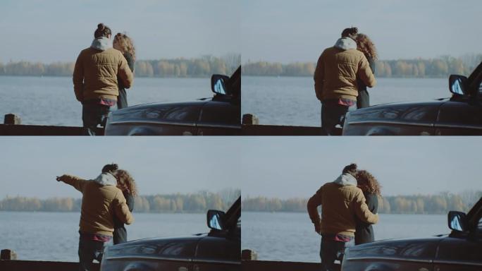 年轻夫妇在湖边拥抱