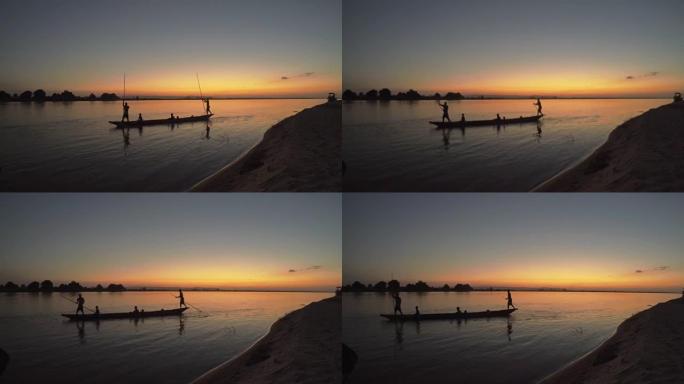 日落时的独木舟夕阳剪影下的船只木筏船小渔