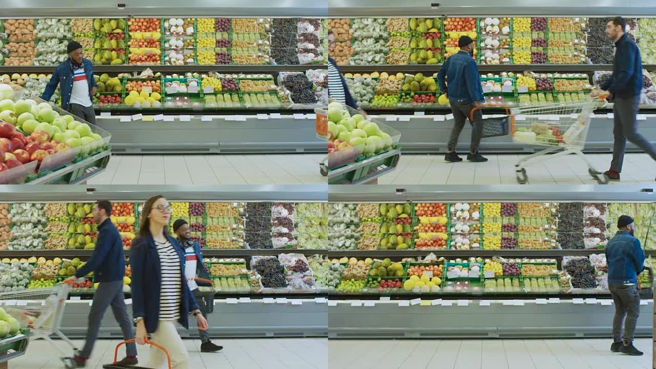 在超市: 快乐的时尚家伙带着购物篮在商店的新鲜农产品区跳舞。大光明购物中心，顾客选择商品和产品。侧视