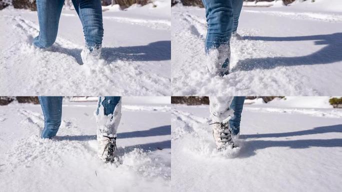 女人在新鲜的雪中深深地走膝盖