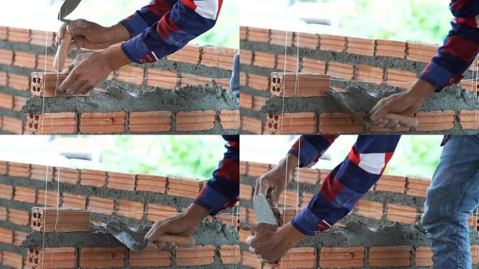 慢动作FHD剪辑特写手工专业建筑工人在新工业场地、建筑行业和砖石概念中铺设砖的镜头