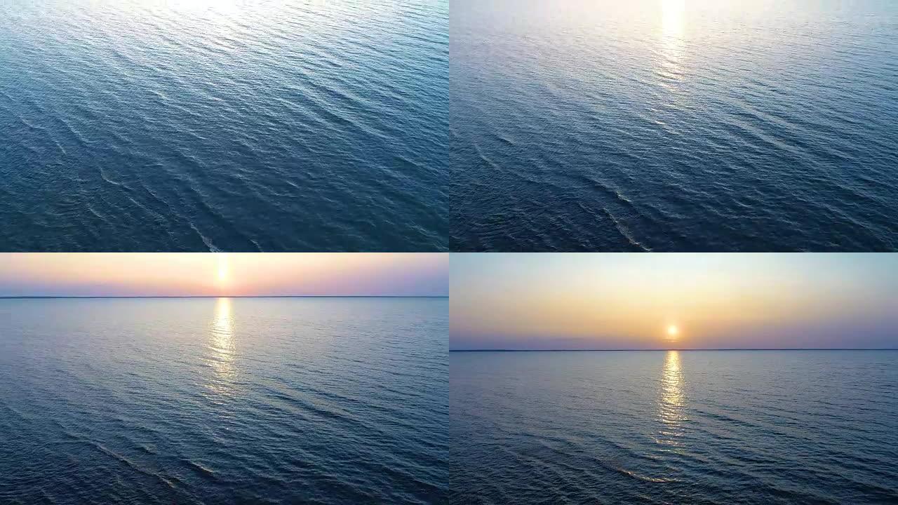 在风景如画的日落背景上的水上飞行。无人机射击