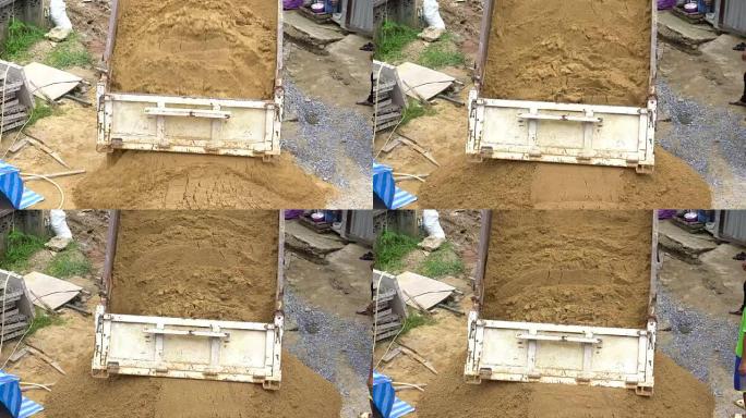 自卸车的4k镜头场景正在新的建筑工地卸砂，建筑行业和砖石概念
