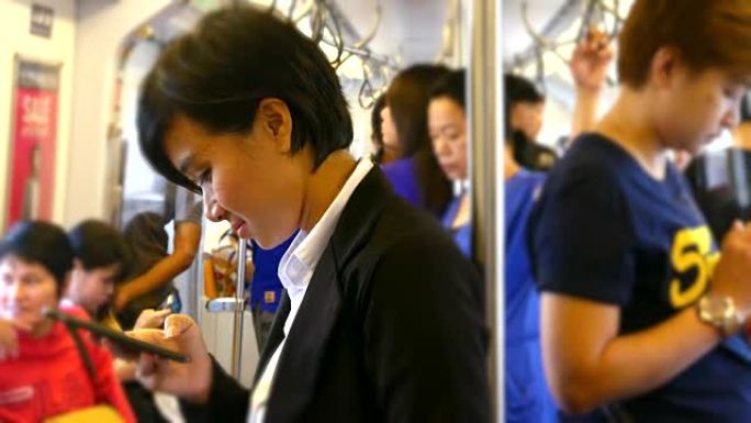 4K: 在火车上使用智能手机的女商人