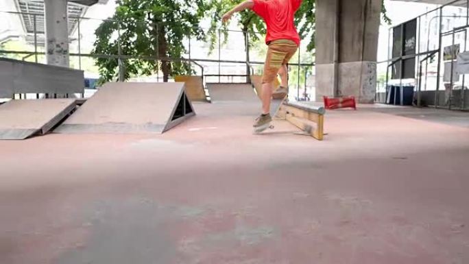 特写慢动作: 滑板运动员的极限运动HDR视频。滑板运动员跳跃kickflip技巧。