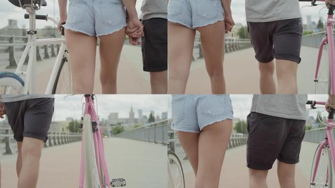 美丽的情侣在城市里骑自行车