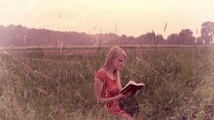 坐在草地上看书的女人。