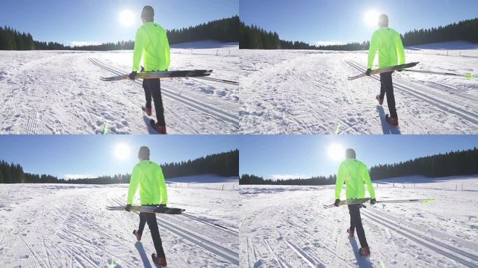 在雪地上行走的年轻男子越野滑雪运动员