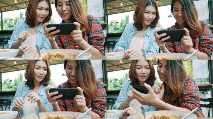 快乐美丽的亚洲朋友女性博客使用智能手机照片，并为她的订阅者和她在咖啡馆的频道制作食物vlog视频。