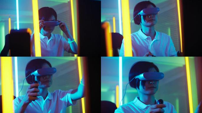 东亚职业玩家戴上虚拟现实耳机，用操纵杆/控制器玩在线视频游戏。房间里很酷的复古霓虹灯颜色。