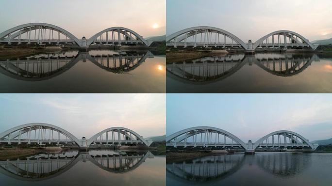 景观和旅行概念，在Lamphun省日落时间与河流反射的Thachompoo桥的4k时间流逝