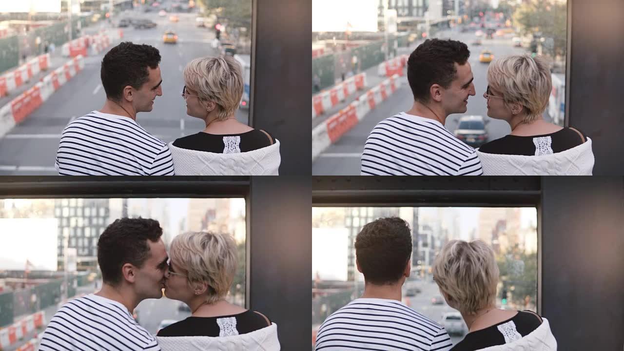 美丽的年轻多民族浪漫情侣站在桥上，欣赏可爱的纽约街景，轻轻地接吻