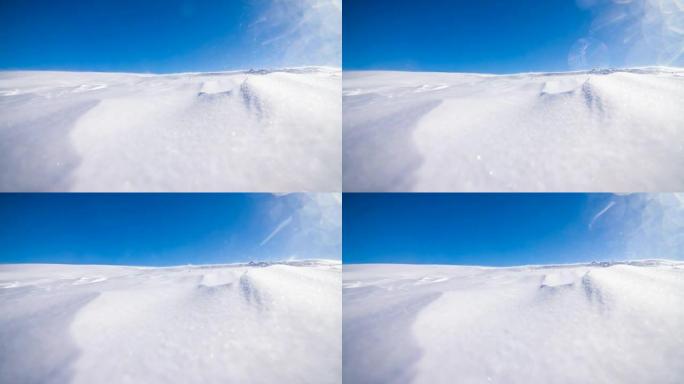 在晴朗的冬日，风吹雪