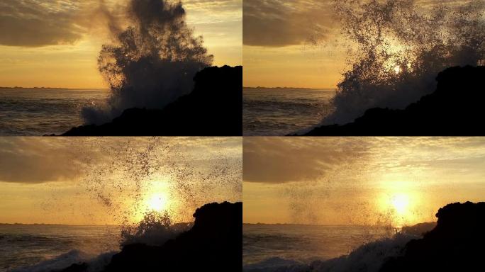 日出时海浪冲击岩石